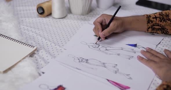 Close up hand of fashion designer man draws a sketch clothing