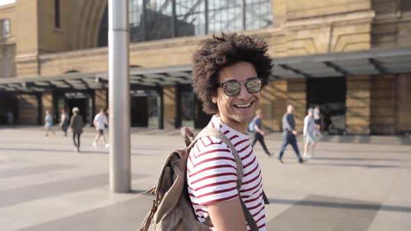 Happy man walking to train station, slow motion