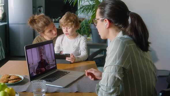 Woman Having Business Call on Laptop at Home