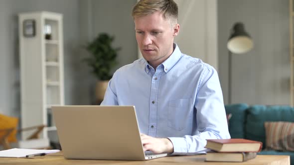 Excited Businessman Celebrating Success at Work