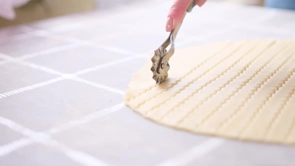 Apple Pie Cake Preparation Series  Woman Slicing Rolled Dough with Rolling Knife