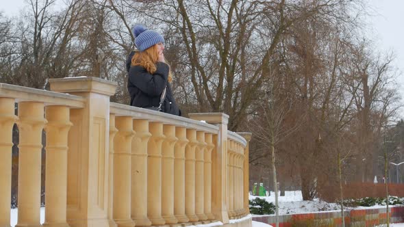 Smiling Woman Talking On Smartphone In Winter