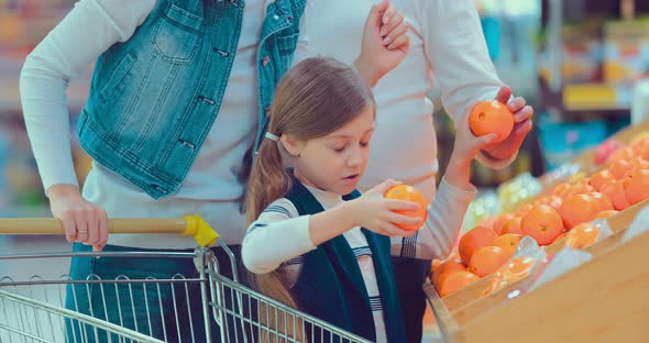 Little Girl is Buying Oranges