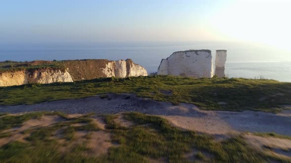 Flying Over The Cliff Edge of Chalk Cliffs at Sunrise