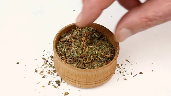 Chef Taking Varied Spices with Pepper and Herbs From Wooden Spice Jar
