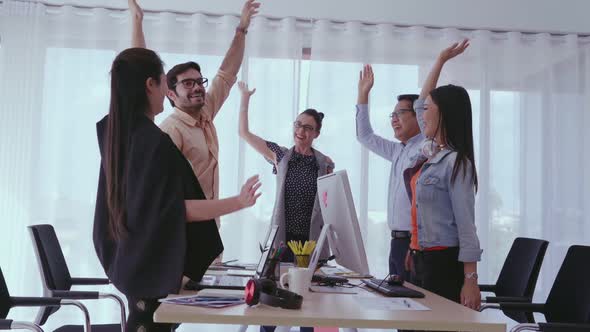 Successful Business People Celebrating Project Success at Office