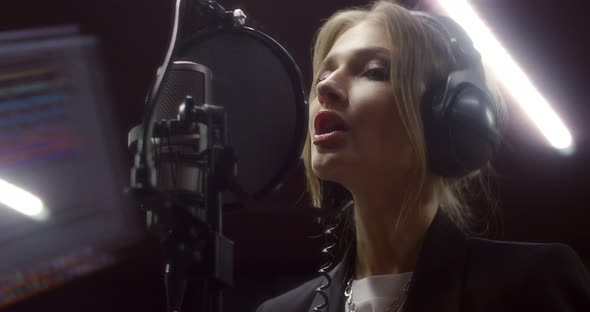 Beautiful Woman Sings a Love Song in Music Studio