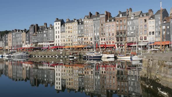 HONFLEUR, FRANCE - SEPTEMBER 2016 Slow tilt water reflection of colorful facades in famous northern 