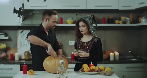 Smiling Young Couple Preparing for a Halloween