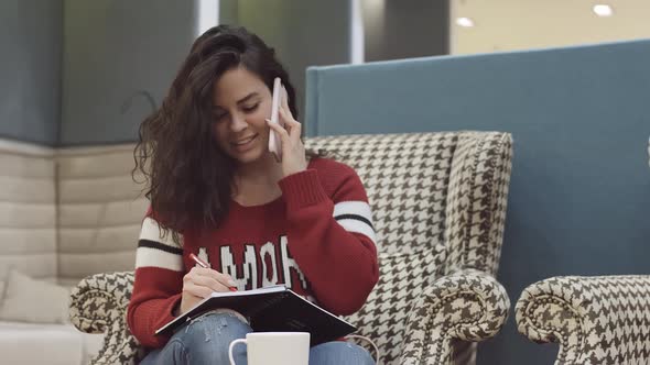 A Young Pretty Girl Works in a Cozy Office