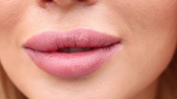 Extreme Close-up Female Mouth with Pink Lipstick Smiling Showing White Healthy Beautiful Teeth