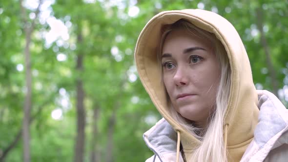 Portrait of a young attractive caucasian woman in casual clothes in the forest