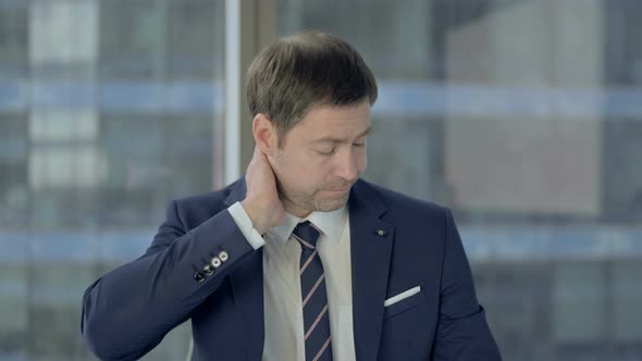 Tired Businessman Having Neck Pain