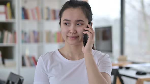 Portrait of Young Asian Woman Talking on Smartphone