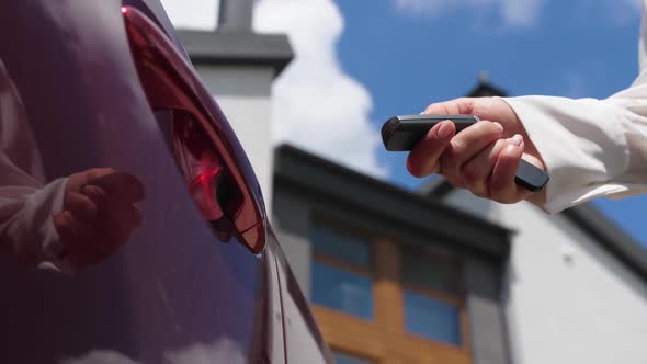 Female Hand Unlocking Car Door with Key Fob