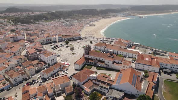Cityscape of Nazare and beach in background, Portugal. Aerial circling