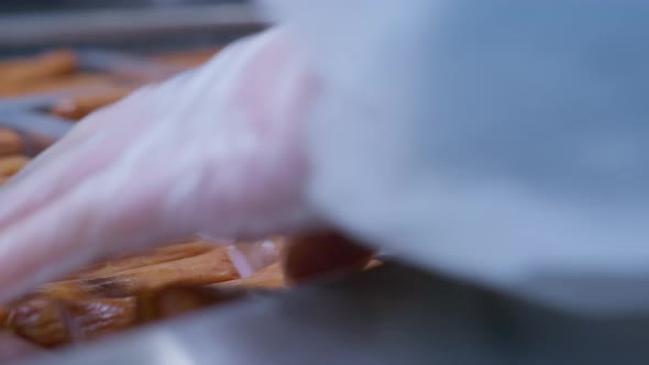 Close Up at the Worker's Hands Placing Readymade Sausages in Plastic Packages