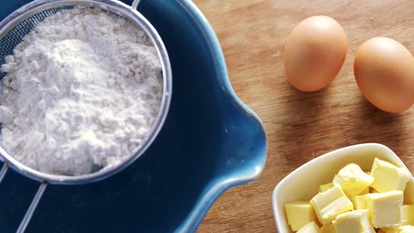 Various ingredients and brown eggs on wooden table 4k