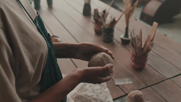 Ceramist Shaping Ball of Clay