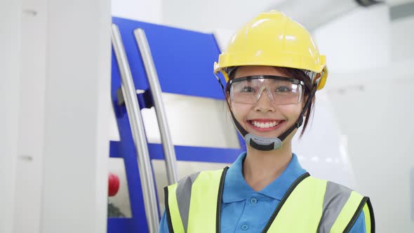 Asian woman worker people wearing protective safety helmet and glasses in production room in factory