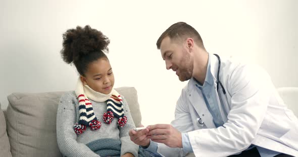 Pediatrician at Home Visiting Helping Little Black Girl