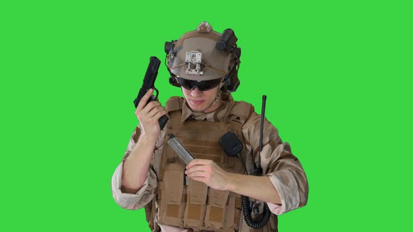 Soldier of Army Elite Forces Walking and Shooting with Pistol on a Green Screen, Chroma Key.