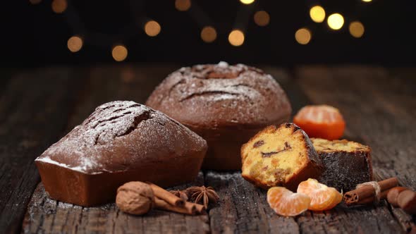 Three Christmas Bread Stollen with Tangerine on a Wooden Textured Table Against the Background of