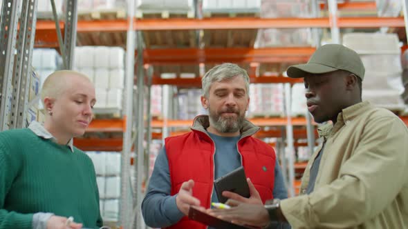 Warehouse Manager Talking with Multiethnic Workers