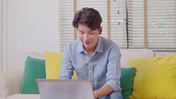 Entrepreneur handsome business asian man wear blue shirt working online with computer laptop on desk