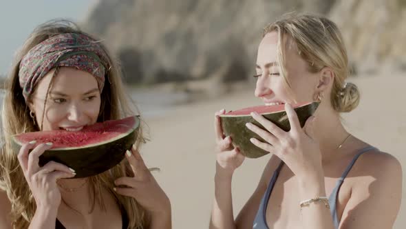 Handheld Shot of Happy Women Eating Watermelon on Beach