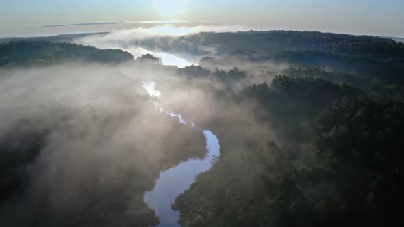 Wonderful aerial view of mist over river in autumn