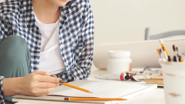 Awesome Positive Blond Woman Enjoying Drawing at Home