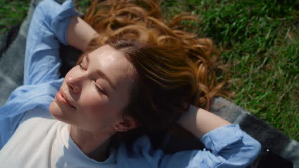 Closeup Happy Girl Lying on Green Grass