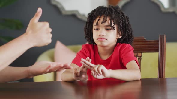 Happy biracial man and his son using sign language