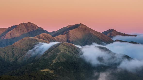 Colors of sunset in mountains above misty clouds in New Zealand nature Time lapse