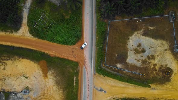 Cinematic Drone Footage of white Mazda Light Vehicle sequences in the middle of the jungle surrounde