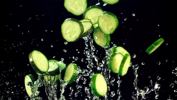 Pieces of Fresh Cucumber Fly Up and Fall with Drops of Water