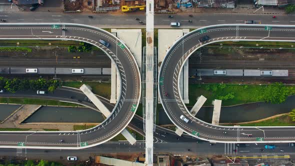 Aerial view of infinity sign traffic junction cross road with car transport.