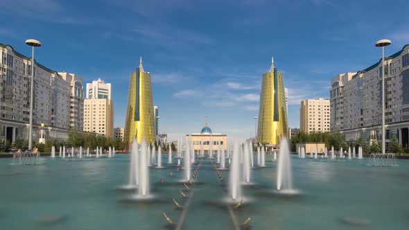 A Square in Front of Ak Orda with Yellow Towers Timelapse Hyperlapse and Fountain in the Foreground