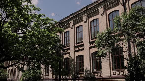 beautiful old brick building on the street with trees