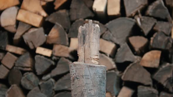 Chopping Wood with an Axe in Woodpile - Axe Gets Stuck in the Log