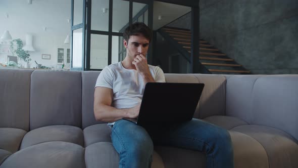 Focused Man Working Computer at Home. Freelancer Looking Computer at Big House.