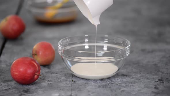 Woman Pastry Chef Whips Cream in Bowl with Mixer Closeup