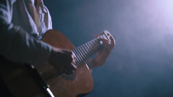 Girl Playing Guitar at Dark Studio