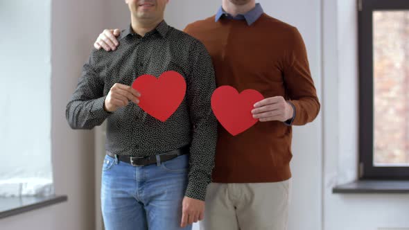 Male Gay Couple with Red Heart Shapes at Home