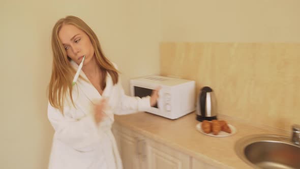 Woman in Bathrobe Hurrying at Home.