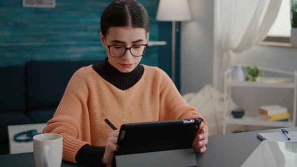 University Student Taking Notes on Digital Tablet with Stylus