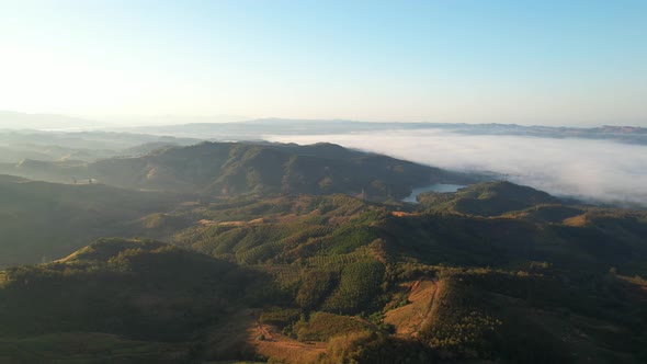 Aerial view of sunrise with fog above mountains