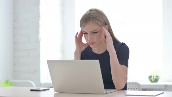 Woman Having Headache While Working on Laptop
