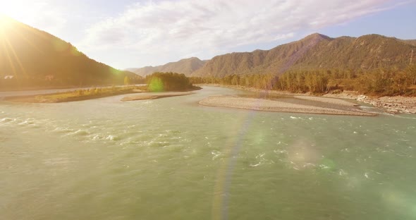 Low Altitude Flight Over Fresh Fast Mountain River with Rocks at Sunny Summer Morning